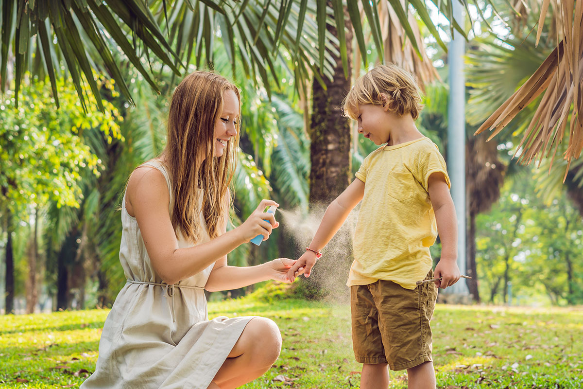woman spraying child